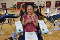 Chloe Emerson manages to smile as she donates blood.