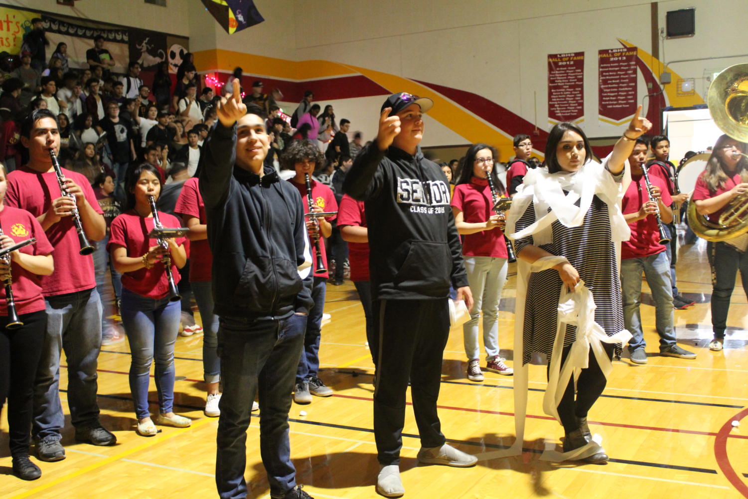 Mrs. Farjardo, still wrapped in toilet paper from the mummy game says the alma mater with the students.
