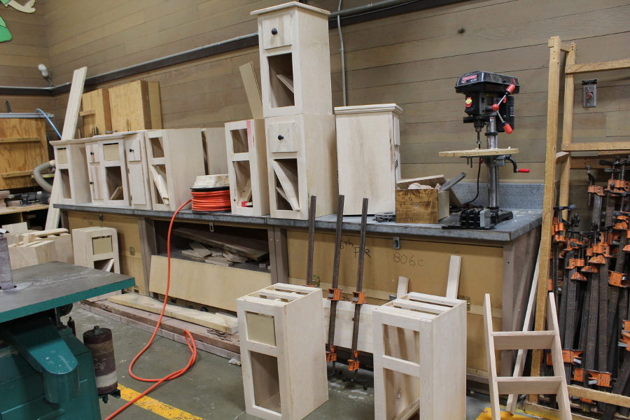 Students make cabinets for the fair.