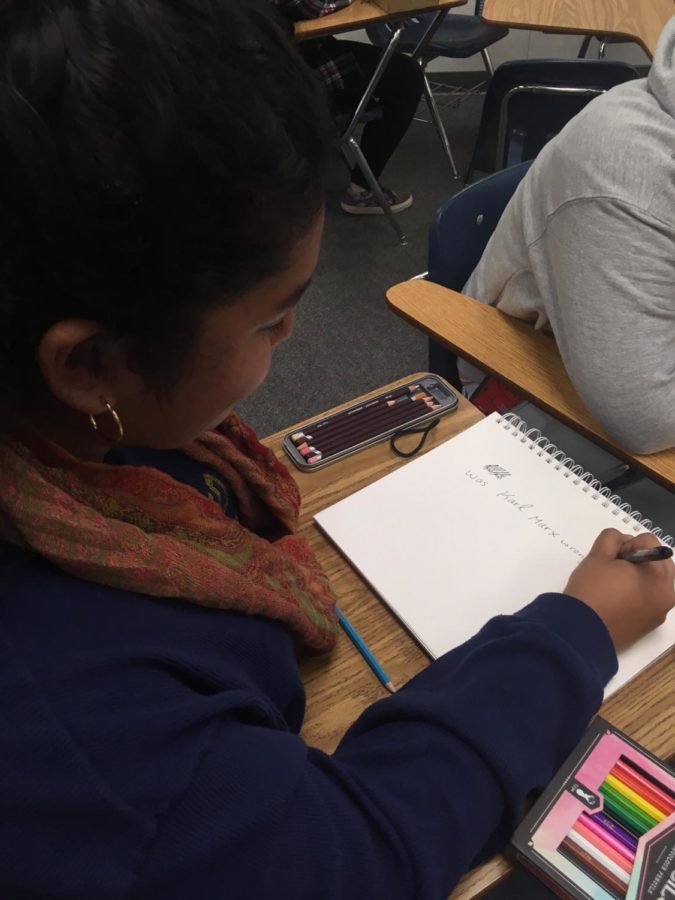 Hannah Padron begins to draft the Open Mic poster after the club meeting.