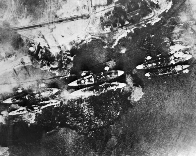 This is an aerial view of the battleships on fire after the attack.