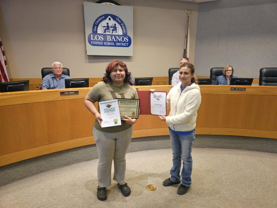 LBHS senior Worm Rangel and art instructor, Mrs. Trinidad Gallegos are presented with awards from the city.