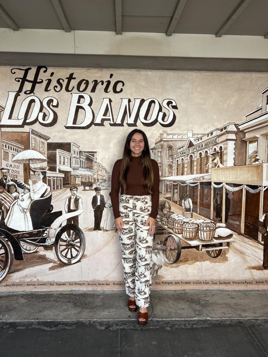 Mrs. Quevedo posing in front of Los Banos History Mural 