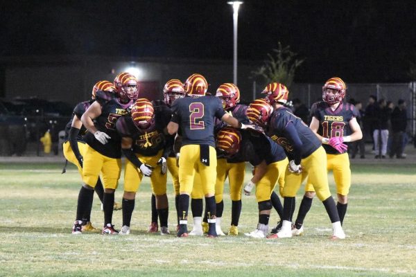 Starting offense for the Los Banos varsity football team in the huddle. 