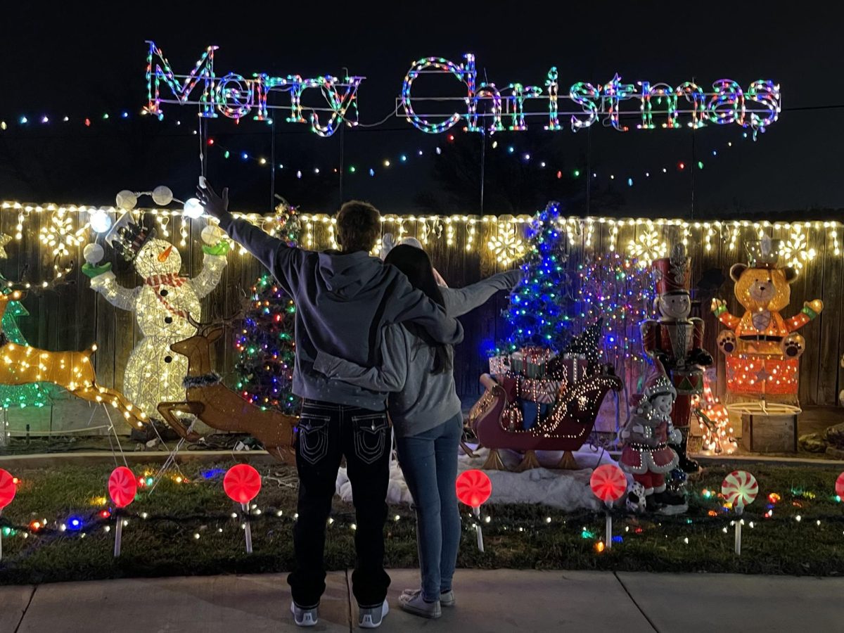 Nevaeh Prado and her partner taking pictures with the Christmas lights.