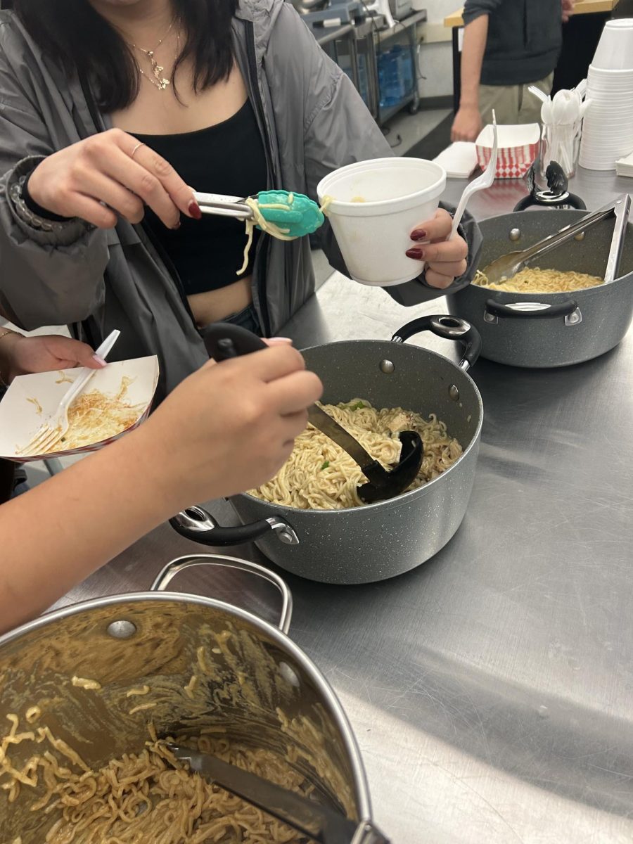 Students make ramen during the activity.