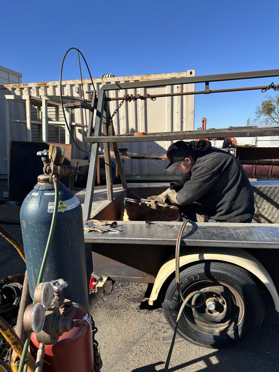 Gage McDonald works on his BBQ trailer in hopes to complete it for fair time.