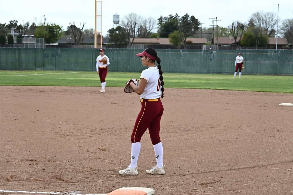 Shayla Hernandez holds down first base and prepares for the play.