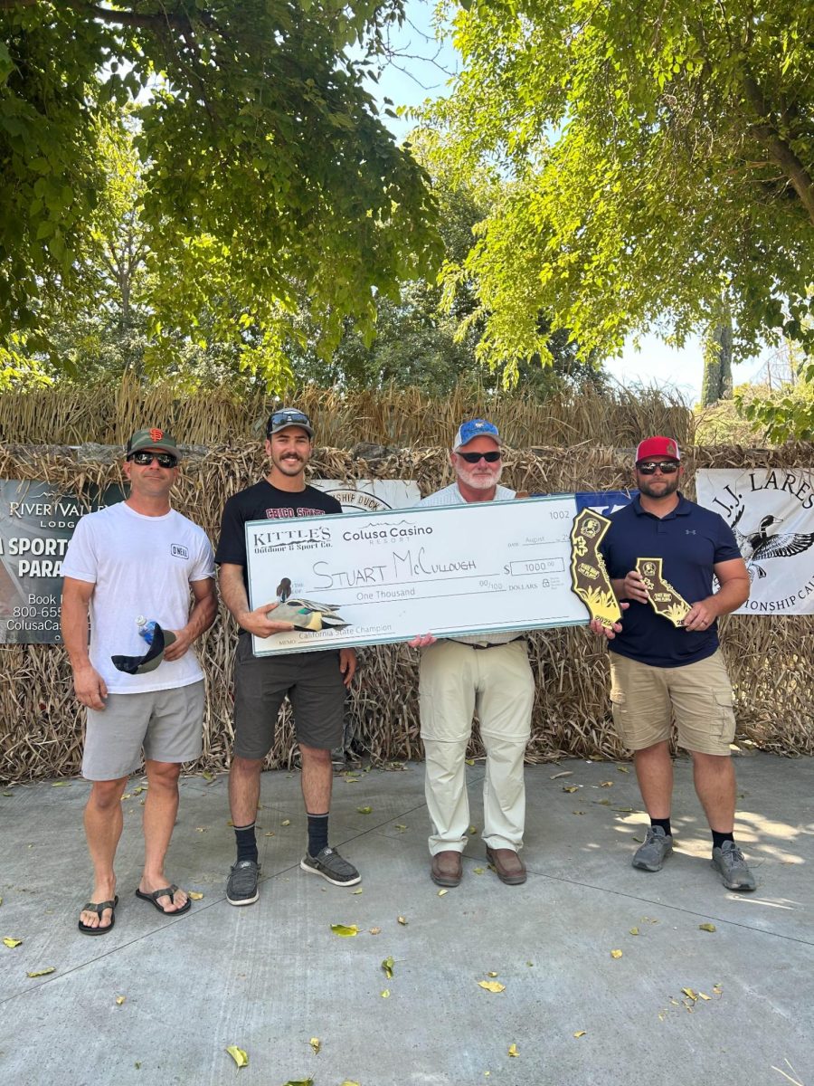 Stuart McCullough, winner of the California State Duck Calling contest stands with his check and other participants.