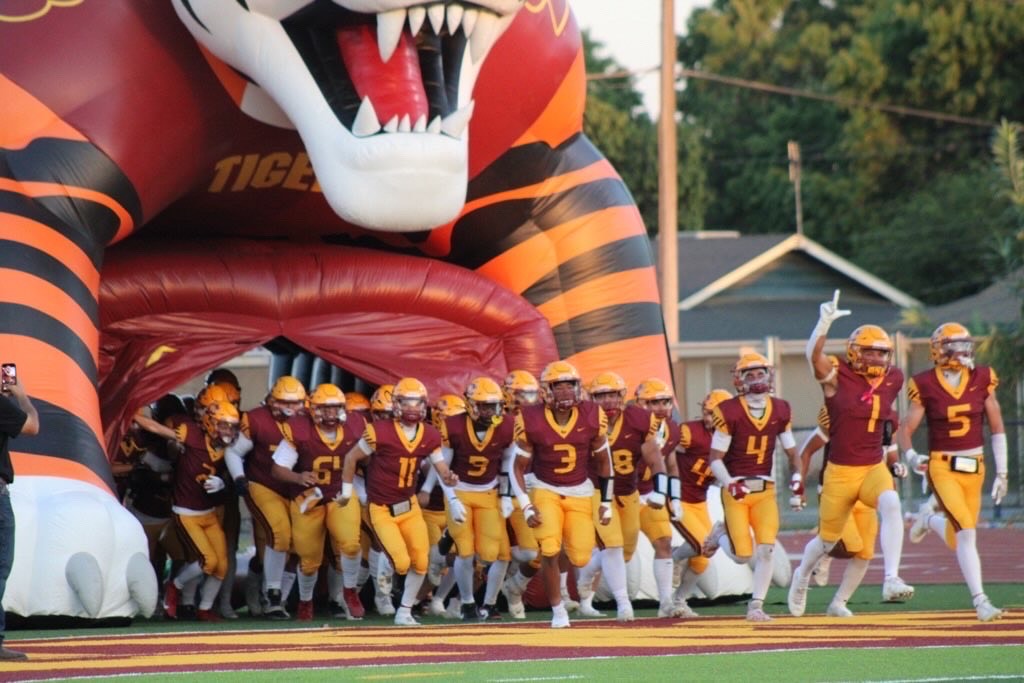 Varsity Football players get pumped up at the start of the game. 