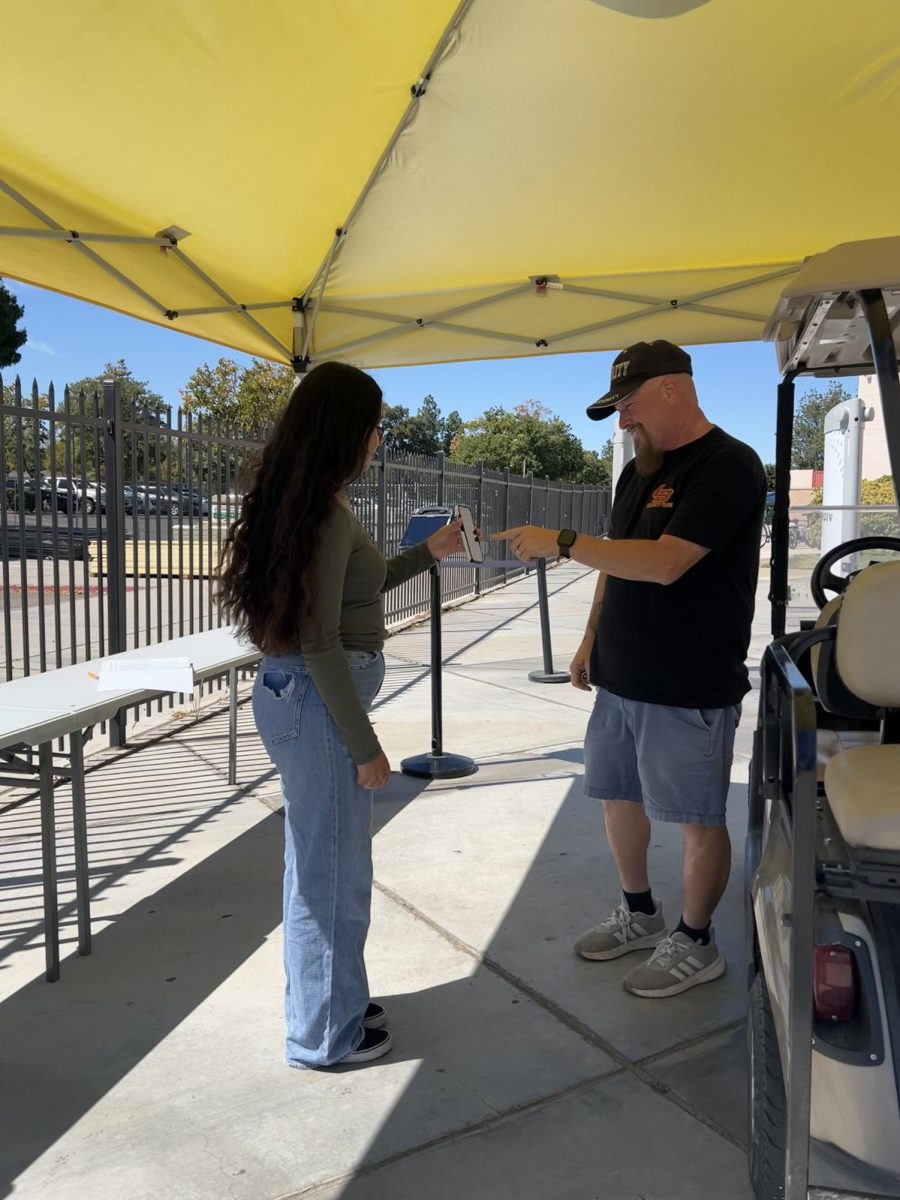 A student gets her lunch pass checked to go off campus.