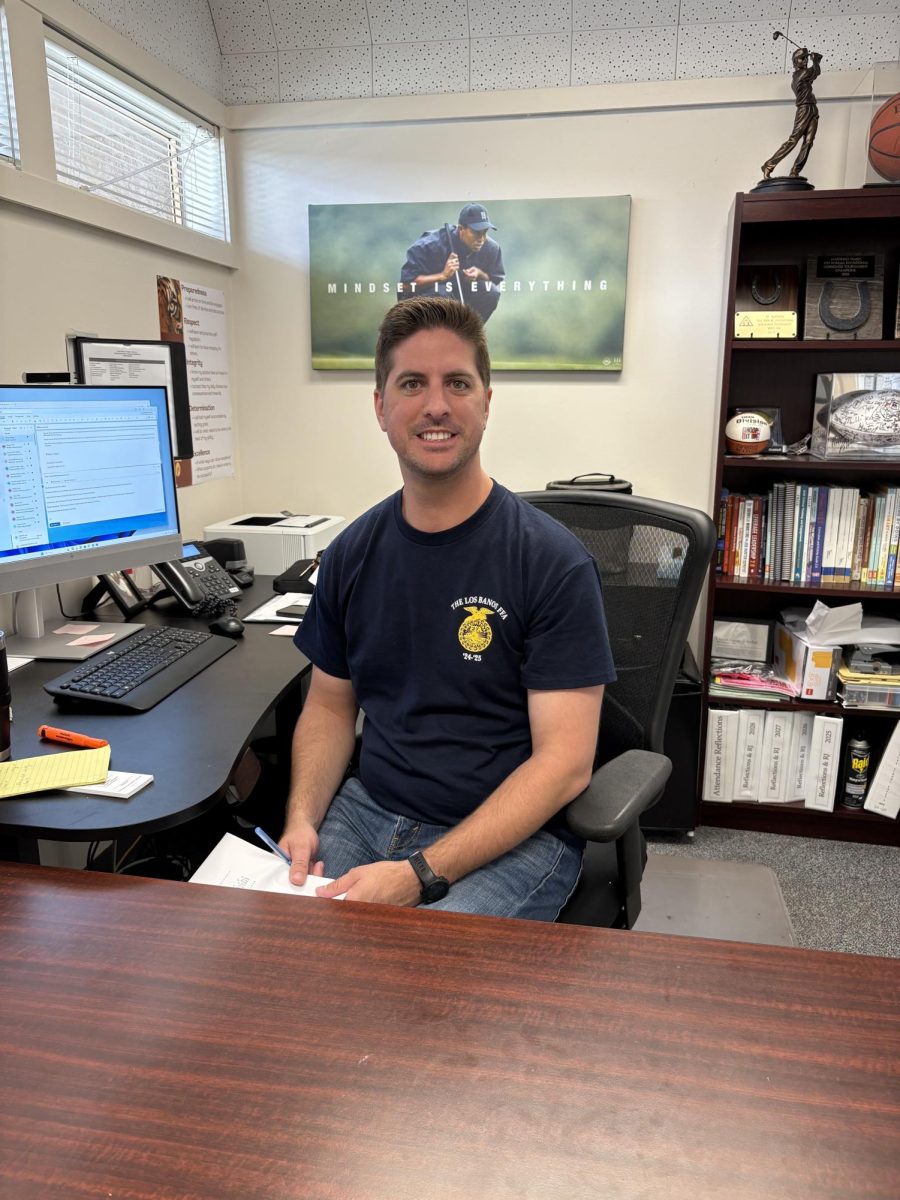Mr. Carson Souza works in his new office as assistant principal.