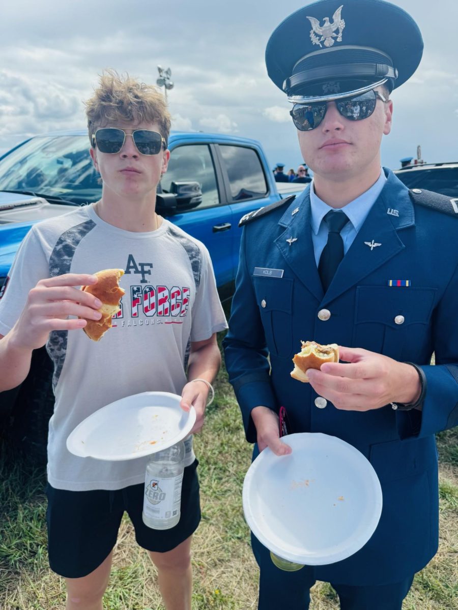 Marshall (right) and his younger brother Hunter Kolb (left) enjoy a tailgate during parents weekend.