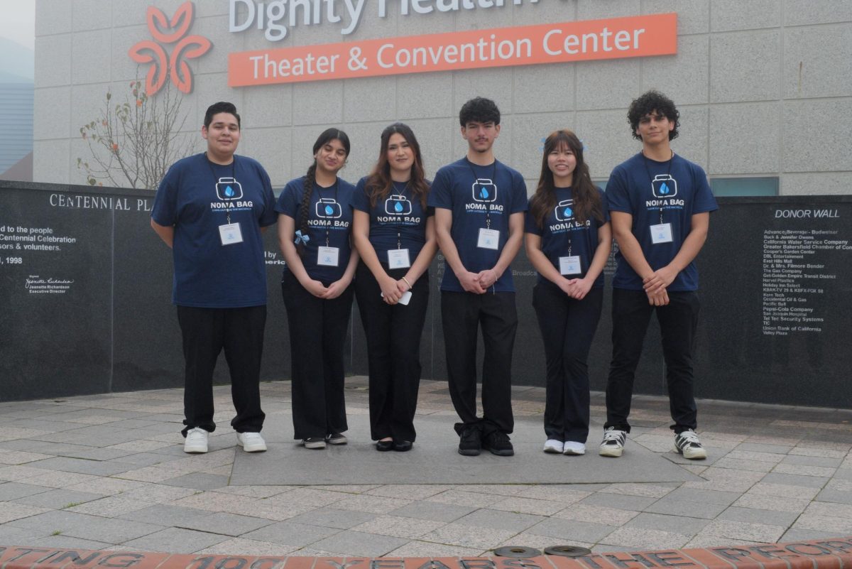 Virtual Enterprise students pose in front of the Dignity Health Arena Convention Center.