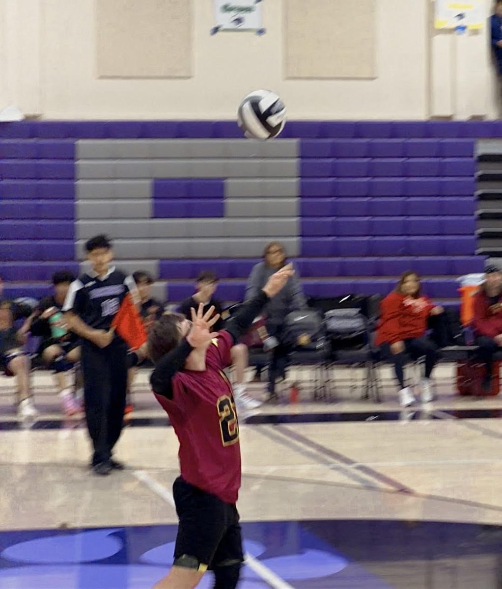 Varsity libero Kavin Parreira serves the ball against the Pacheco Panthers.