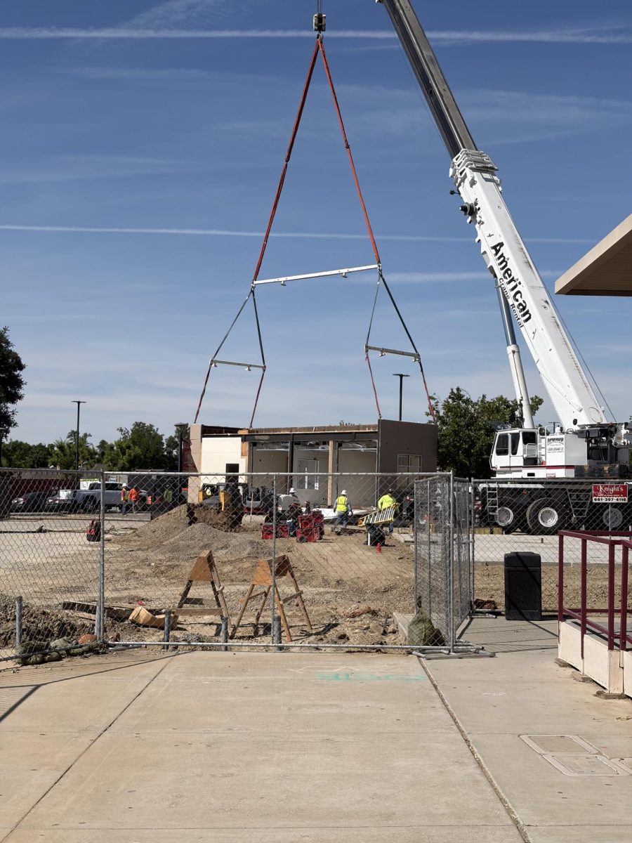 Crane positions new parts of front office.